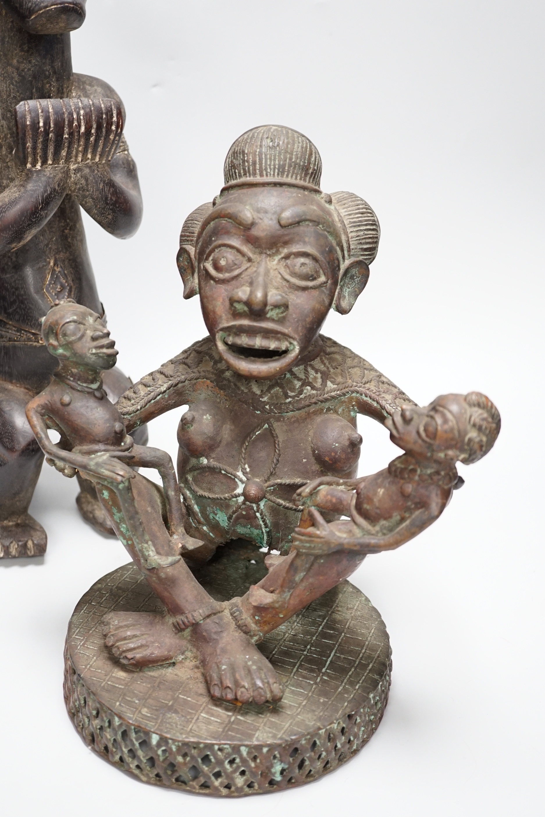 A Yoruba bronze group and a hardwood figure, tallest 47cm